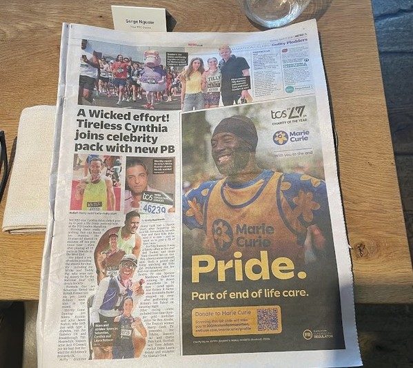 The Metro newspaper page five, 28 April 2026, full-page Marie Curie Charity-of-the-Year advertisement featuring Serge Nguélé and the headline 'Pride. Part of end of life care'